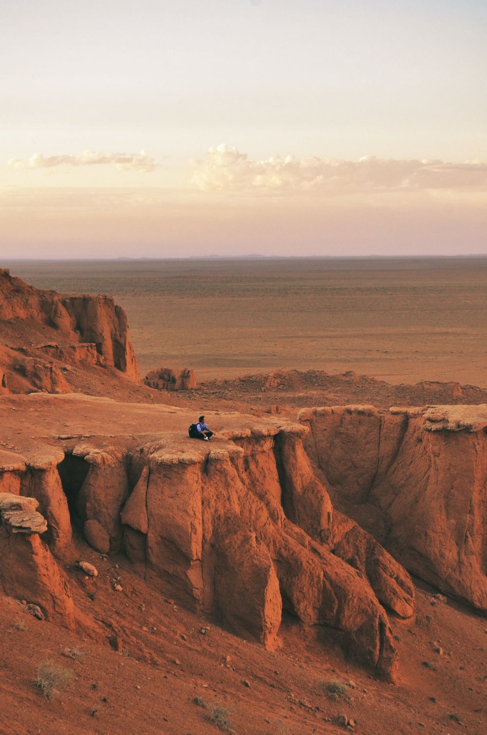 A man on flaming cliffs in Mongolia
