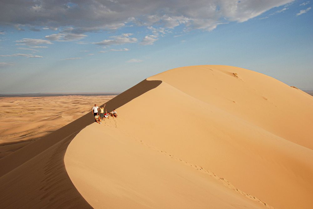 people on a dune of desert