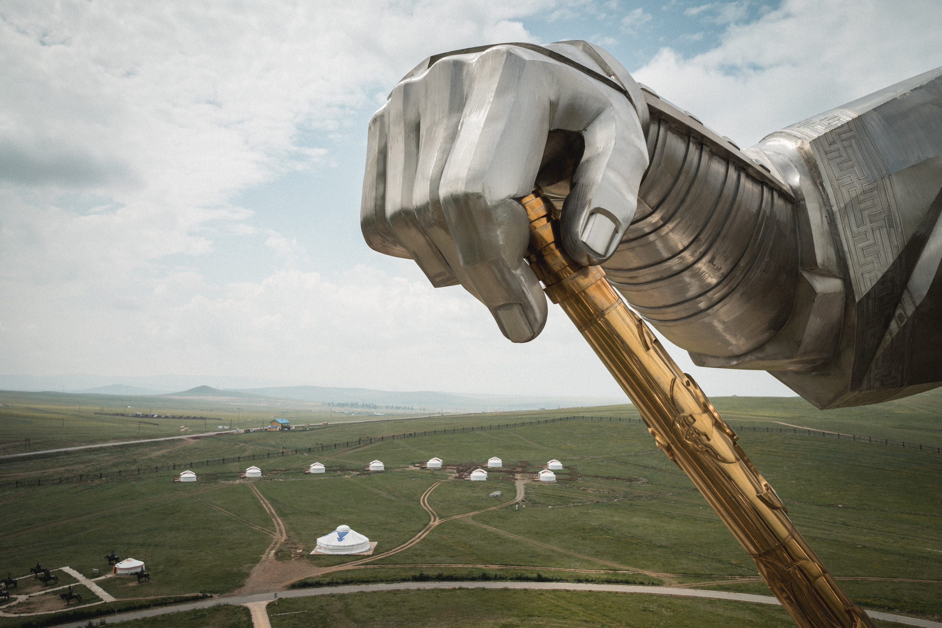 A picture of a person standing in front of the statue of Genghis Khan in Mongolia