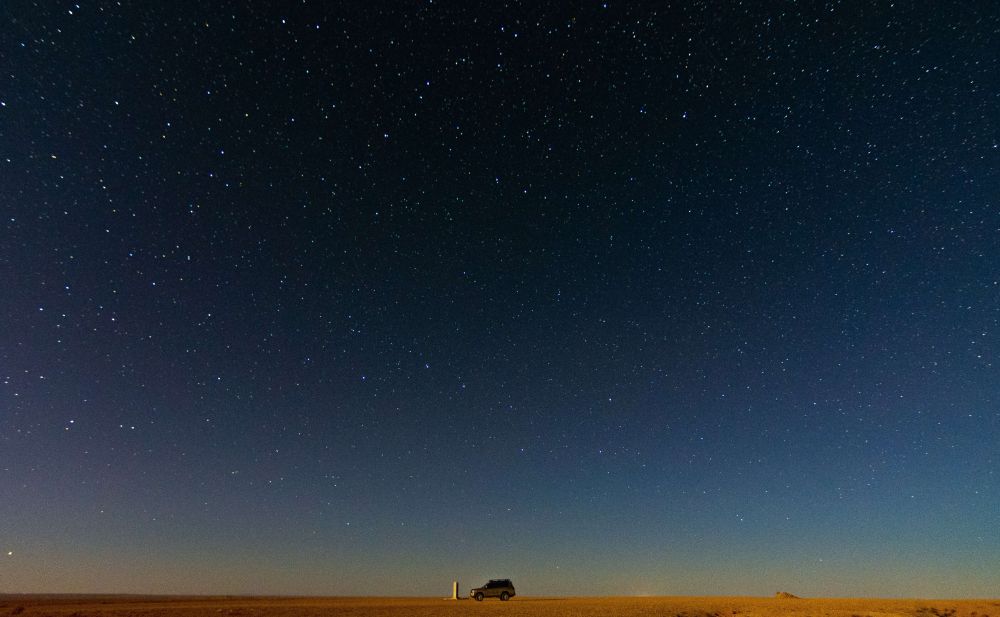 4x4 vehicle under clear night sky